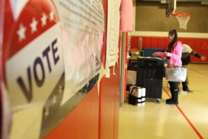 Jamie Litvaitis votes at Maple Hill Elementary School in Naugatuck in November 2012. This year people who haven’t registered to vote can do so on Election Day.  –RA ARCHIVE