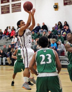 Naugatuck’s Mick Pernell puts up a shot Monday night at home versus Wilby. Pernell scored 21 points as the Greyhounds upset the Wildcats, 80-72. 