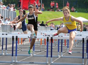 Woodland’s Alina Martinez, left, jumps over a hurdle as Seymour’s Diana Janus clears a hurdle of her own during the 100 meter hurdles at the NVL girls track and field championships Tuesday in Beacon Falls. The Woodland girls won the meet title, the NVL Brass Division title and the league championship by defeating Watertown, 150-136.5. The Naugatuck girls tied for third with Holy Cross at the meet. –LUKE MARSHALL 