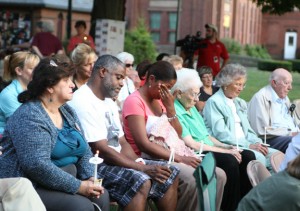 Laura Suazo, center, and her husband, Andre Suazo, listen to a song in honor of, William Smolinski Jr., a Waterbury man who has been missing for nine years, during a vigil on the Naugatuck Town Green Sunday. Laura Suazo's son, Andrew Garcia, has been missing since October 2011. –RA ARCHIVE