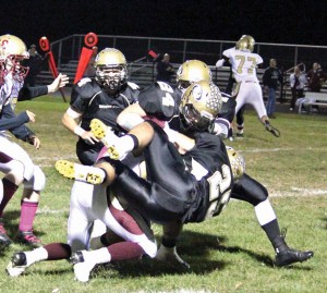 Woodland’s Taylor Tucciarone (24) and Coby Vaccarelli (25) tackle Sacred Heart’s Carmen Perugini on a kickoff return Oct. 25 in Beacon Falls. Woodland beat Sacred Heart, 54-6, to improve to 7-0. –ELIO GUGLIOTTI 