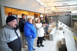 Naugatuck High School Principal Janice Saam, center, talks about the work being done in the pool area of Naugatuck High School during a tour of the ongoing renovations Dec. 14. From left, Burgess Rocky Vitale, Board of Education Vice Chairman Dorothy Neth-Kunin, Burgess Michael Bronko, O&G Industries Vice President Michael Brennan, O&G Industries Project Manager Joe Vetro and Tax Collector Jim Goggin listen. –LUKE MARSHALL 