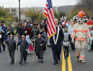 Lt. John Debisschop of the Naugatuck Fire Department leads the annual Halloween parade in 2012 with his triplet sons (dressed as the Three Blind Mice) Jeffrey, John and Jack. Debisschop is among several borough firefighters who have twins or triplets. –FILE PHOTO 