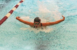 Naugatuck’s Erica Spino does the butterfly stroke during the 200 medley relay Oct. 3 versus Woodland at Naugatuck High School. The Greyhounds won the meet 97-85. –LUKE MARSHALL