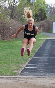 Woodland’s Lauren Lombardo competes in the long jump during a track meet against Sacred Heart and Kennedy May 5 at Woodland. –LUKE MARSHALL