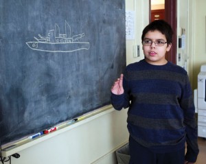 Xavier Bliege, 11, and a student at Hillside Intermediate School, draws a picture of the U.S.S. Missouri in Naugatuck on Monday. Bliege has a fascination with world history, including battleships from the World War I era. Several miniature model ships that he has crafted were displayed at the Whittemore Library. -REPUBLICAN-AMERICAN