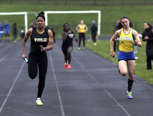 Woodland's Erika Michie, left, sprints to the finish ahead of Seymour's Sarah Granese in the 4x100 relay during a meet with Kennedy and Waterbury Career Academy in Beacon Falls on Tuesday. -REPUBLICAN-AMERICAN