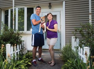 Frank and Anita Finkle, with their dog Rusty, stand for a photograph at their Cotton Hollow Road home in Naugatuck June 24. The borough is planning on widening Cross Street, a move that would include knocking down Finkle's home, another home and shaving pieces off other yards along Cross Street. –REPUBLICAN-AMERICAN